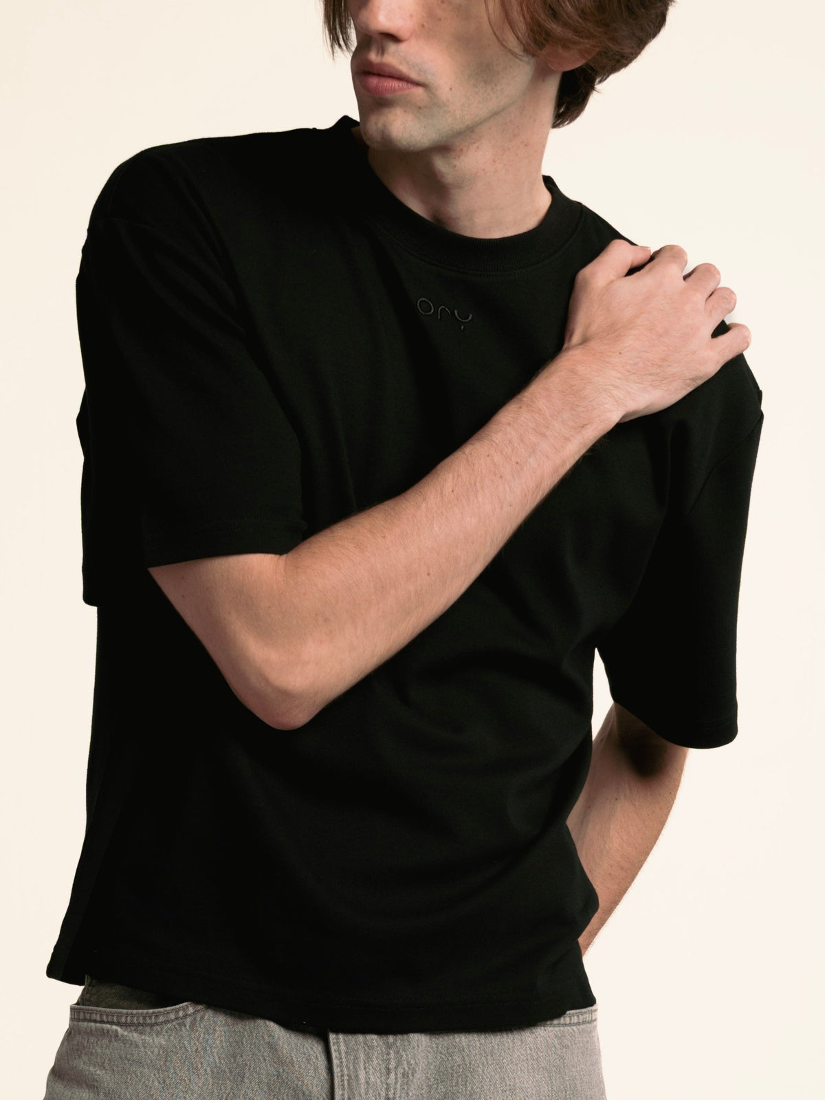 Three-quarter view of the black ORY Origin T-Shirt on a male model