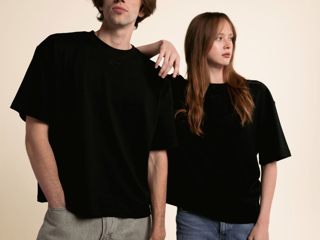 Man and woman wearing the ORY Origin T-Shirt in black, a boxy unisex tee