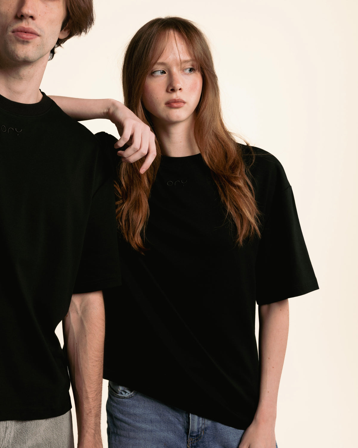 Woman wearing the boxy black ORY Origin T-Shirt with jeans