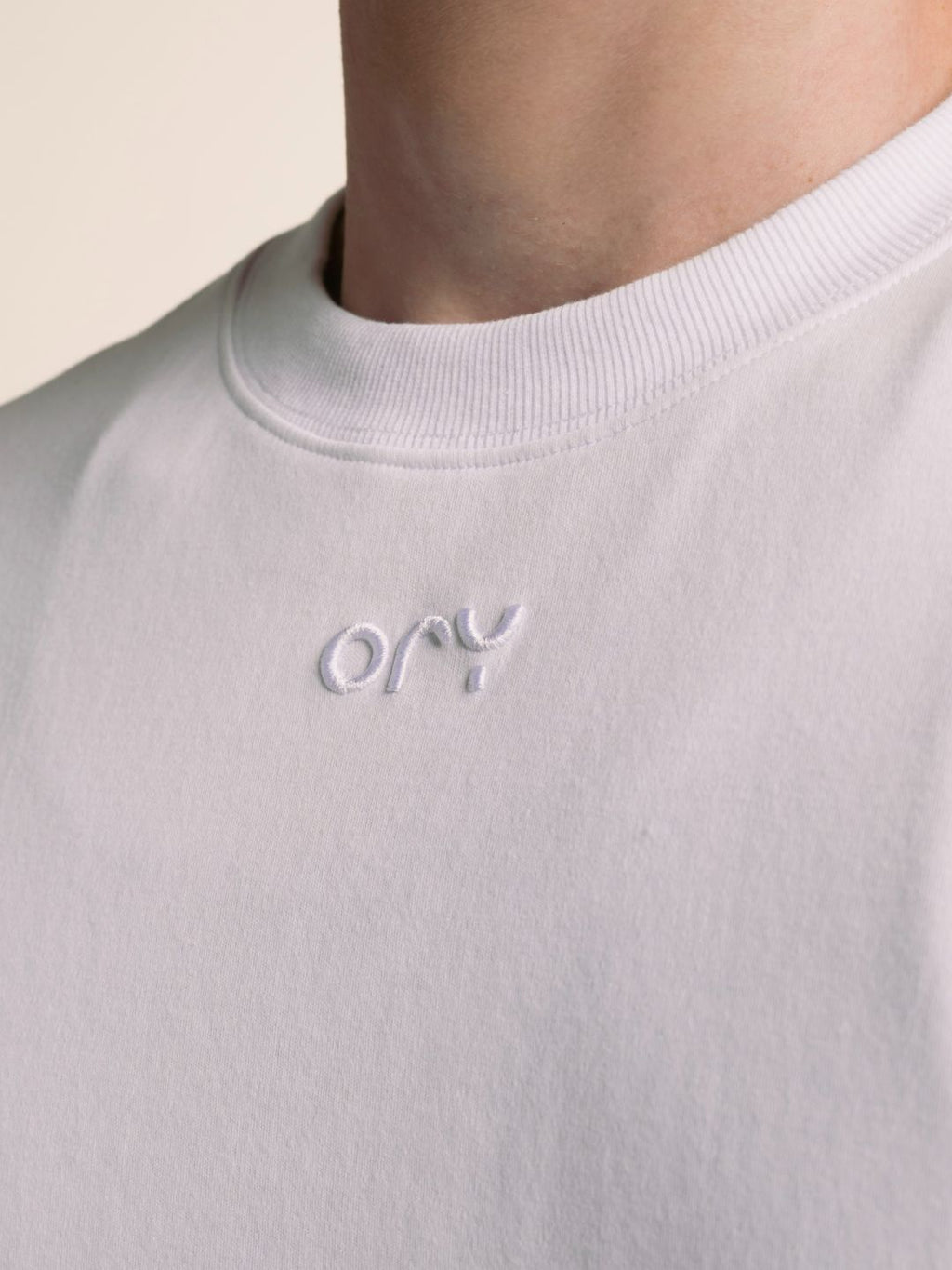 Embossed ORY logo detail on the chest of the white Origin T-Shirt