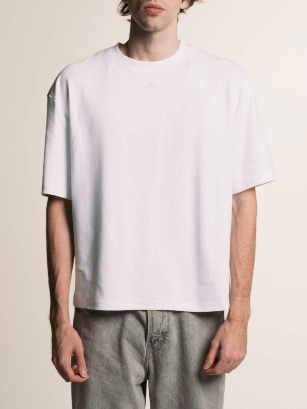 Man wearing the boxy white ORY Origin T-Shirt, front view