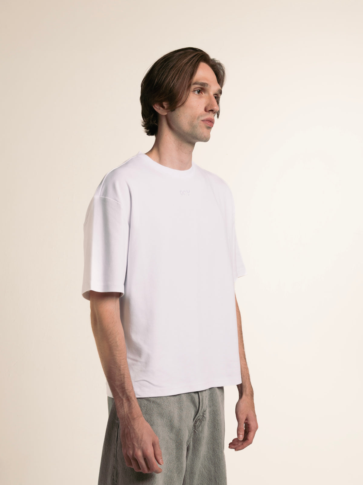 Side view of the white ORY Origin T-Shirt on a male model
