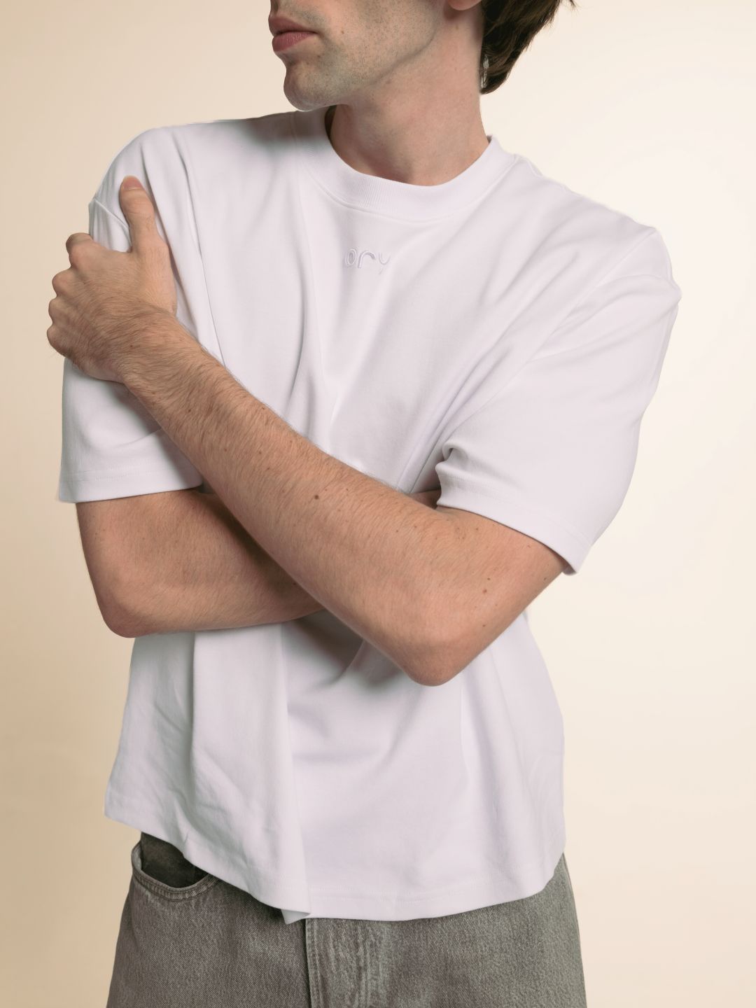 Man in the white ORY Origin T-Shirt with arms crossed