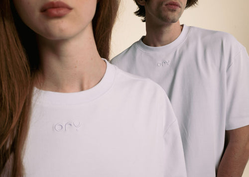 Woman and man wearing the white ORY Origin T-Shirt with embossed logo