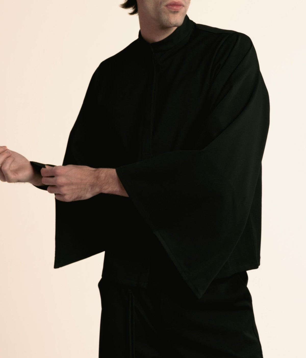 Man wearing the black ORY Kimo Shirt with wide kimono sleeves