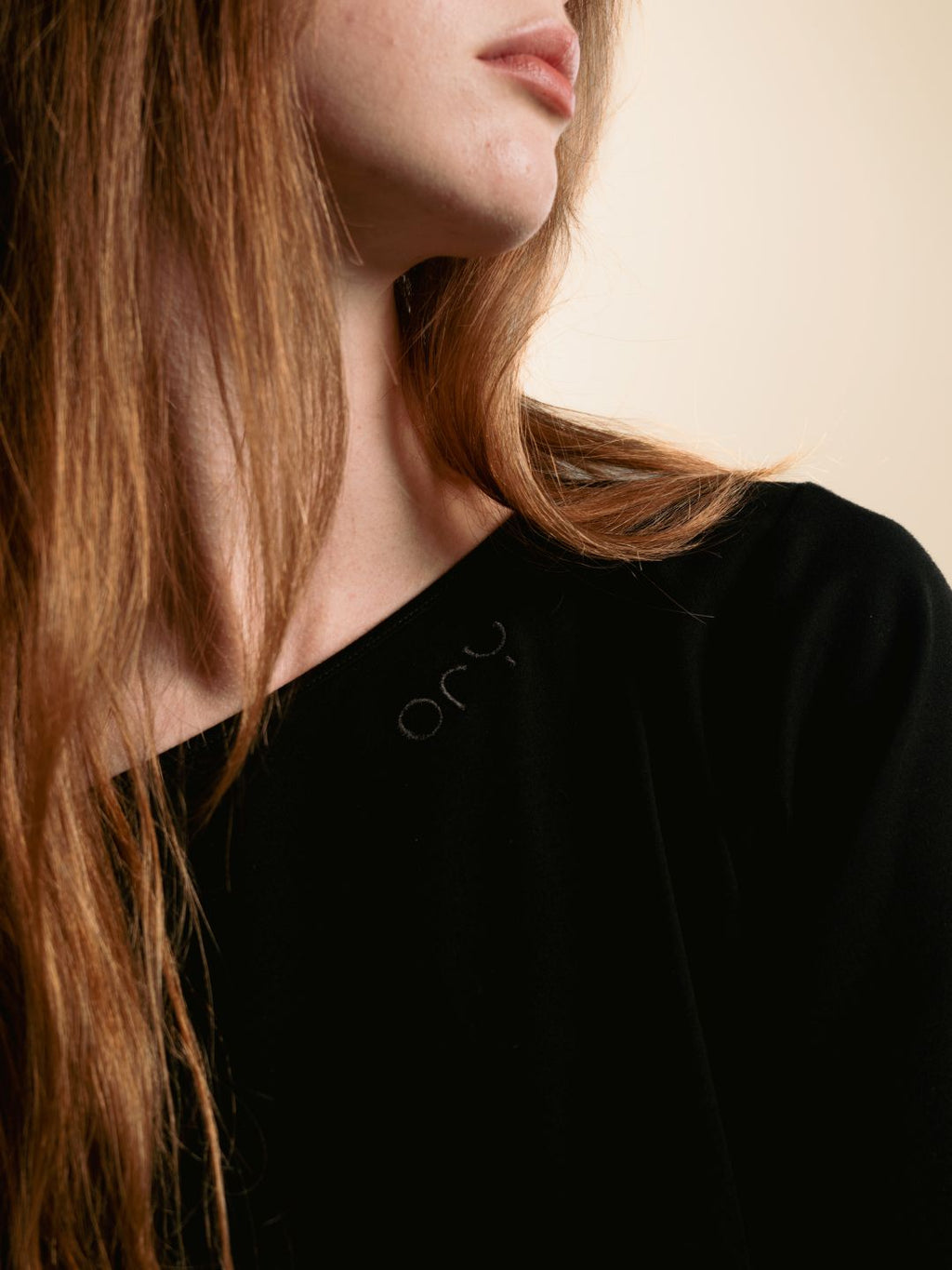 Tonal ORY logo near the neckline of the black Kimo Off-Shoulder Top