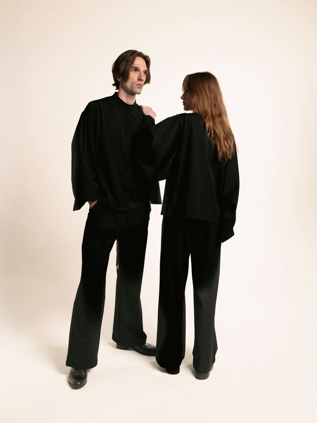 Man and woman wearing black ORY Origin wide-leg trousers with the Kimo Shirt
